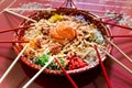 Serving of yusheng or yee sang with raw salmon belly during Chinese New Year with chop sticks laid around plate for good Royalty Free Stock Photo