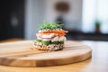 sesame bagel with chive cream cheese on a wooden board Royalty Free Stock Photo