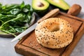 Sesame bagel on wooden cutting board Royalty Free Stock Photo