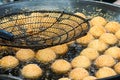 Sesame balls frying in hot oil