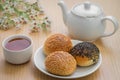 Sesame buns on plate and tea cup