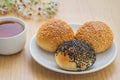 Sesame buns on plate and tea cup Royalty Free Stock Photo