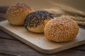 Sesame buns on wooden plate Royalty Free Stock Photo