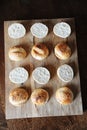 Sesame burgers buns split in half on wooden cutting board top view. Cooking process