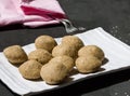 Closeup view of Indian sweet made of sesame seeds on Makar Sankranti.Also called Til Ladoo,Til Laddu in India,on black background.