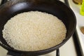 Sesame is fried in a cast iron pan in the home kitchen. The preparation process for the traditional Tahini sauce.