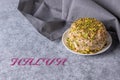 Sesame halva, gray napkin and halva text on gray background