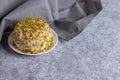Sesame halva with nuts and gray napkin on gray background