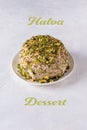 Sesame halva with pistachios on white with Halva dessert text