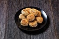 Sesame lamb patties on a black plate