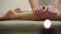Sesame oil massage for calf muscle. Relaxation treatment for young female, close up