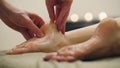 Sesame oil massage for heel foot. Relaxation treatment for young woman, close up