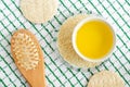 Sesame oil and seeds in the small bowl. Wooden hairbrush. Ingredients of diy face and hair masks and moisturizers. Homemade beauty Royalty Free Stock Photo
