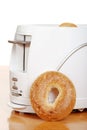 Sesame seed bagel leaning on toaster Royalty Free Stock Photo