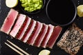 Sesame Seed Crusted Seared Tuna served with wasabi and sauce closeup. Top view horizontal Royalty Free Stock Photo