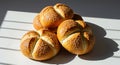 Sesame Seed Kaiser Rolls Stacked on White Surface with Shadow Play Royalty Free Stock Photo