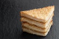 Sesame seeded prawn toasts on black stone background