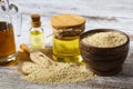 Sesame seeds in sack and bottle of oil on wooden rustic table Royalty Free Stock Photo