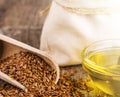 Sesame seeds in sack and bottle of oil on wooden rustic table on sunlight Royalty Free Stock Photo