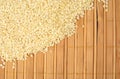 Sesame seeds scattered on wooden mat in the corner