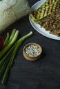 Sesame seeds in a wooden bowl. Roasted sesame seeds. Raw, whole, unprocessed. Natural light. Selective focus. Dark wooden