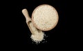 Sesame seeds in wooden bowl and scoop isolated on black background. top view. Spices and food ingredients