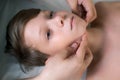Session of craniosacral therapy, cure of teen boy's jaw by a doctor therapist. Royalty Free Stock Photo