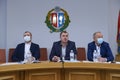 Session of regional council. Head center and his deputies with masks over faces sitting at the presidium and keeping speach