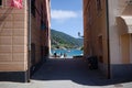 Access to sea, beach and Baia del Silenzio bay through narrow passage between tworesidential buildings