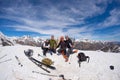 Group of alpinists selfie on mountain top. Scenic high altitude background on snow capped Alps, sunny day.