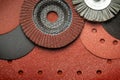 A set of abrasive tools and grinding discs on the background of sandpaper. Essential tools for master builders
