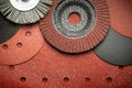 Set of abrasive tools and grinding discs on the background of sandpaper. Essential tools for master builder