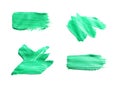 Set with abstract brushstrokes of green paint on white background