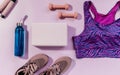 Set of accessories for fitness, yoga. Bra, pink block for yoga, bottle for water, dumbbells, sneakers, skipping rope