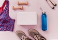 Set of accessories for fitness, yoga. Bra, pink block for yoga, bottle for water, dumbbells, sneakers, skipping rope on pink