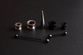 Set of accessories for piercing on a dark background Royalty Free Stock Photo