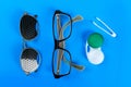 A set of accessories for sight. Medical concept. Pinhole glasses, lenses with container and glasses for sight. Top view Royalty Free Stock Photo