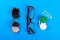 A set of accessories for sight. Pinhole glasses, lenses with container and glasses for sight. Pair of medical pinhole glasses with