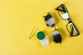 A set of accessories for sight. Pinhole glasses, lenses with container and glasses for sight. Pair of medical pinhole glasses with