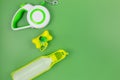 Set of accessories for walking your dog: leash, bottle for water, dog cleaning bags on green background. Pet care and training