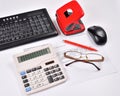 Set for accounting: invoice, keyboard, calculator, mouse, hole punch, glasses and red pen Royalty Free Stock Photo