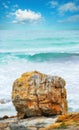 Set against the mighty oceans. A single rock set against a oceanic background at the coast.