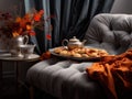 Velvet Reprieve: Chaise Lounge with Silk Cushions and Autumnal Tea Setting on a Gradient Gray Canvas Royalty Free Stock Photo