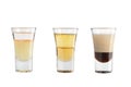 Set of alcohol shots on a white background. Three shots of a variety of alcoholic