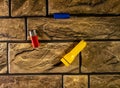A set of all-different objects for photographic purposes against the background of a brick wall in close-up.