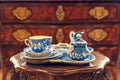 Set of ancient tableware on wooden table in museum