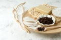 Set for anti-cellulite massage procedures. Coffee scrub, coffee grains, sea salt, soap, sponge on wooden plate and gray background