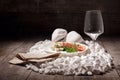 A set of appetizers on a wooden background. Wineglass and plate of meat and roquefore on white rocks. Luxury concept.