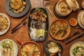 set of asian food dishes Pekin duck, noodles, Vietnamese rolls, bao bread, cutlery