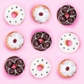 Set of assorted and delicious donuts isolated on pink background. Top view, flat lay Royalty Free Stock Photo